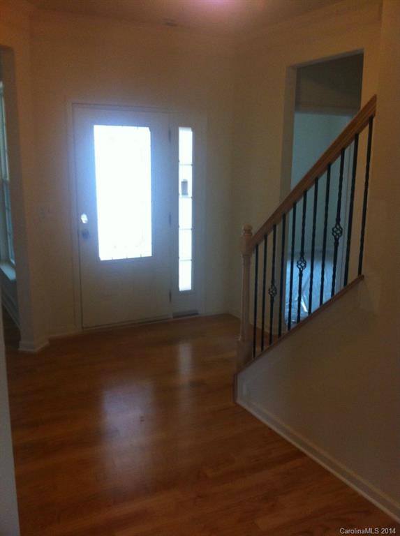 4266 Perth Road, Unit 311 Indian Land, SC 29707 - Photo 10 of 12 a view of an empty room with wooden floor and a window