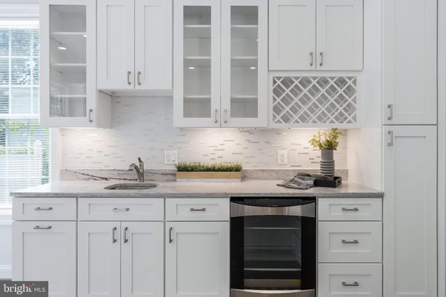 a kitchen with granite countertop a sink cabinets and window