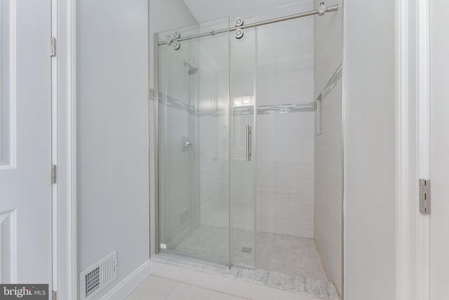 a bathroom with a glass shower door
