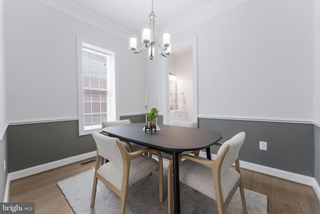 a view of a dining room with furniture and chandelier
