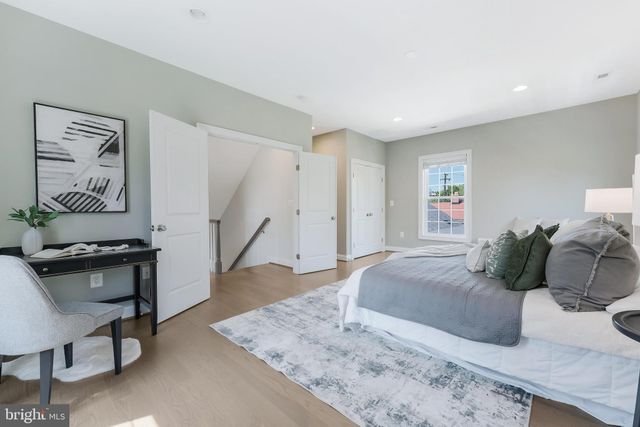 a bedroom with furniture and a wooden floor