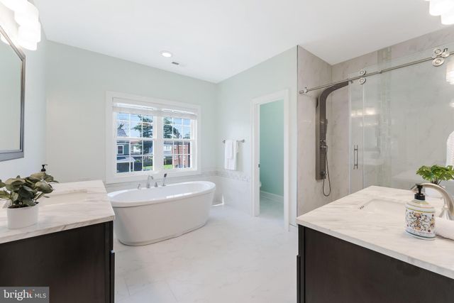 a bathroom with a sink a tub and a mirror