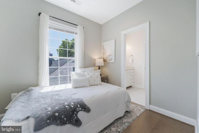 a bedroom with a large bed and a window