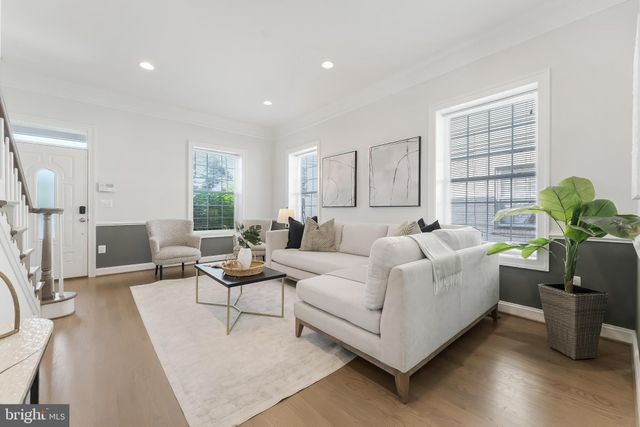 a living room with furniture potted plant and a window