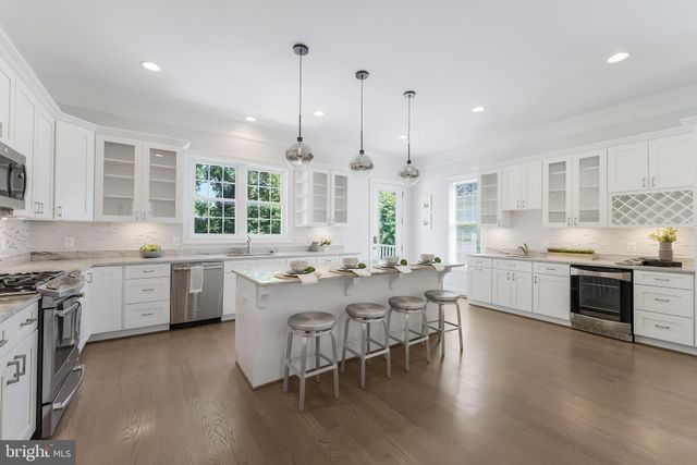 a large kitchen with a table and chairs