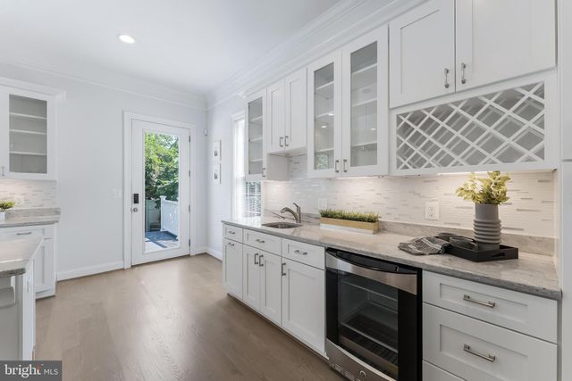 a kitchen with stainless steel appliances granite countertop a sink a stove and cabinets