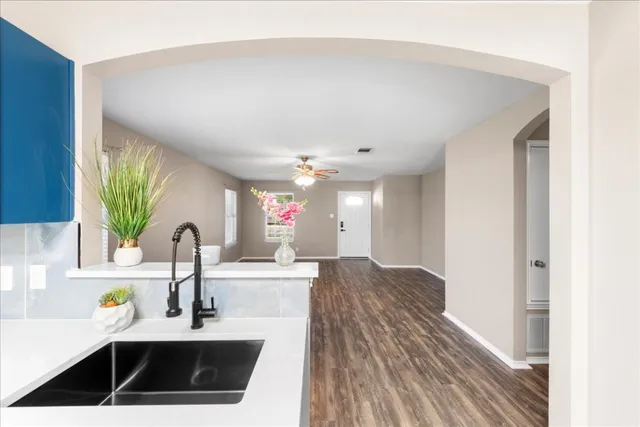 a kitchen with kitchen island granite countertop a sink stainless steel appliances and cabinets