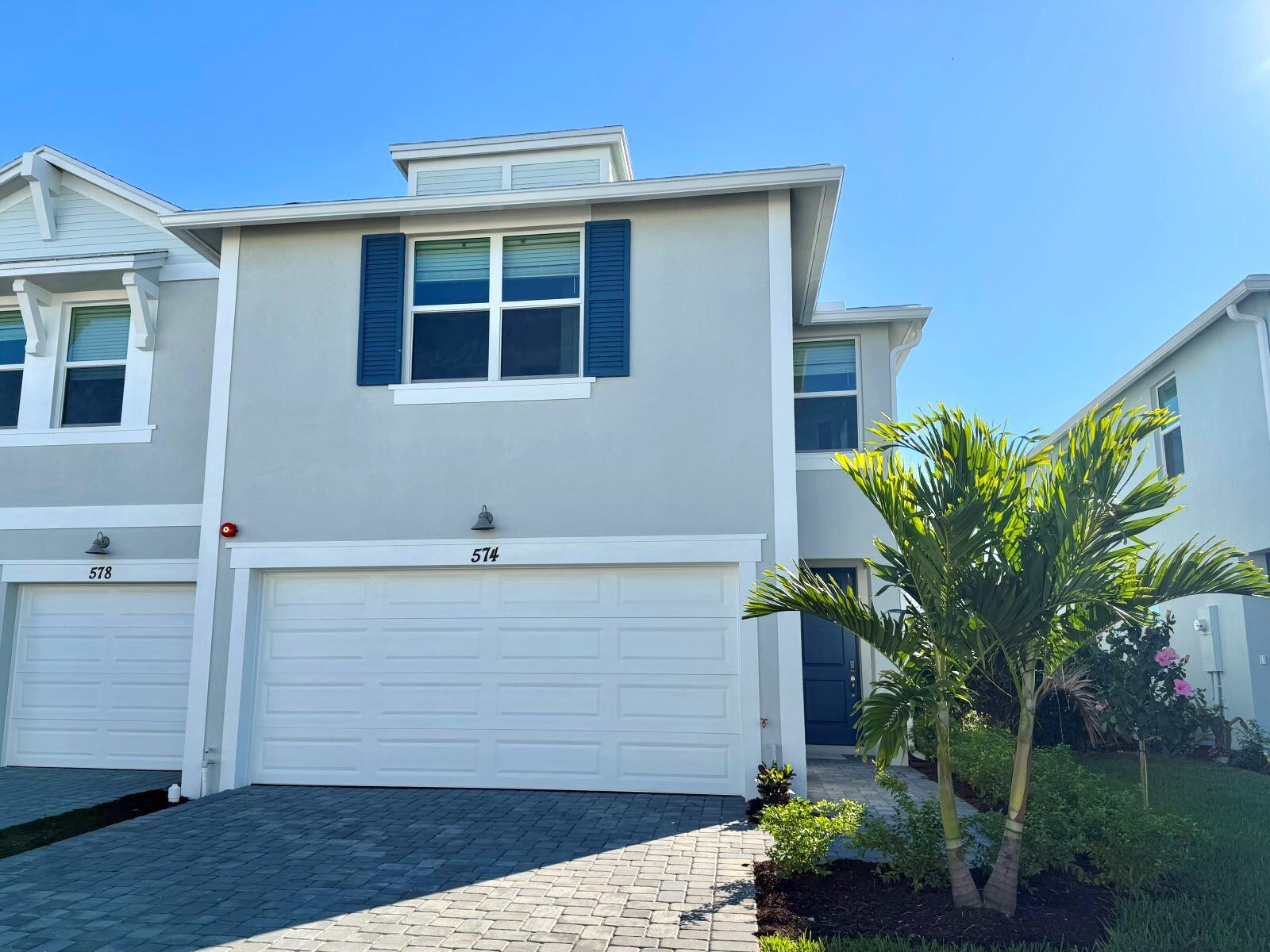 574 Salisbury Circle Fort Pierce, FL 34982 - Photo 1 of 10 a front view of a house with garden