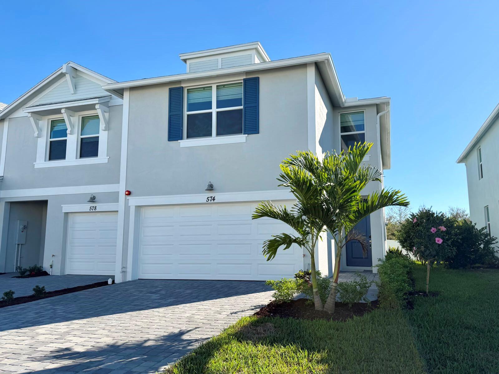 574 Salisbury Circle Fort Pierce, FL 34982 - Photo 2 of 10 a front view of a house with garden