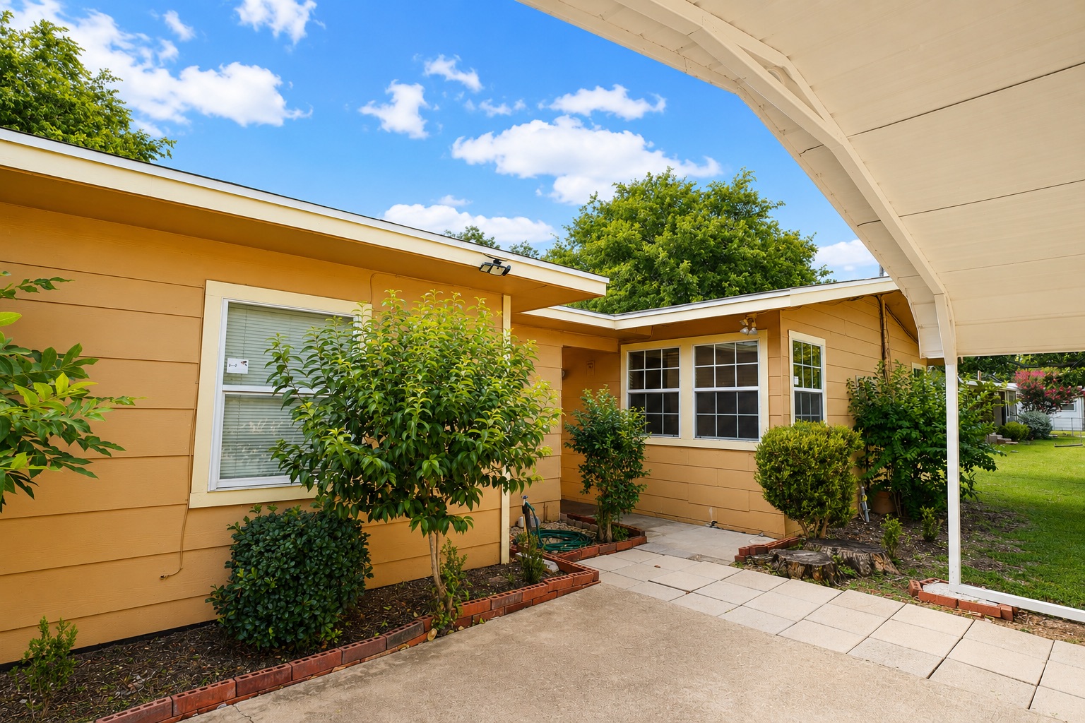 1508 Walnut Street Georgetown, TX 78626 - Photo 8 of 37 A welcoming carport provides shelter and convenience to this charming home's entrance.