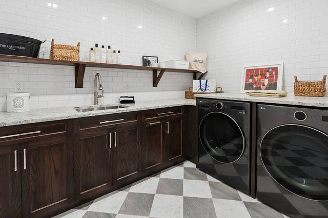 a kitchen with a sink a stove and cabinets