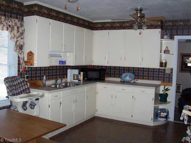 310 Summit Road High Point, NC 27265 - Photo 5 of 9 Other. This spacious kitchen has a new floor and has plenty of cabinets, a stove & refrigerator.