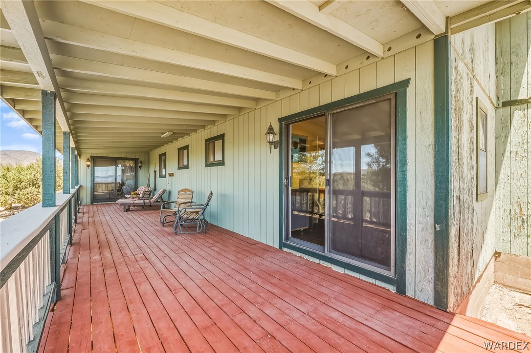 2401 North Stephan Road Kingman, AZ 86401 - Photo 22 of 92 Expansive covered wood deck featuring a rich red-brown finish and white railing