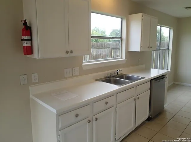 a kitchen with a sink and cabinets
