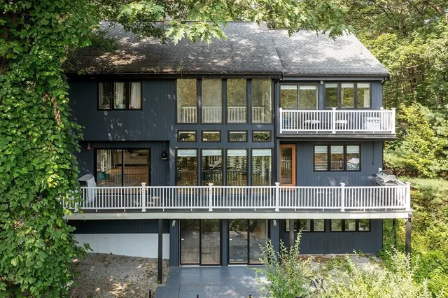 a aerial view of a house yard fire pit and large tree