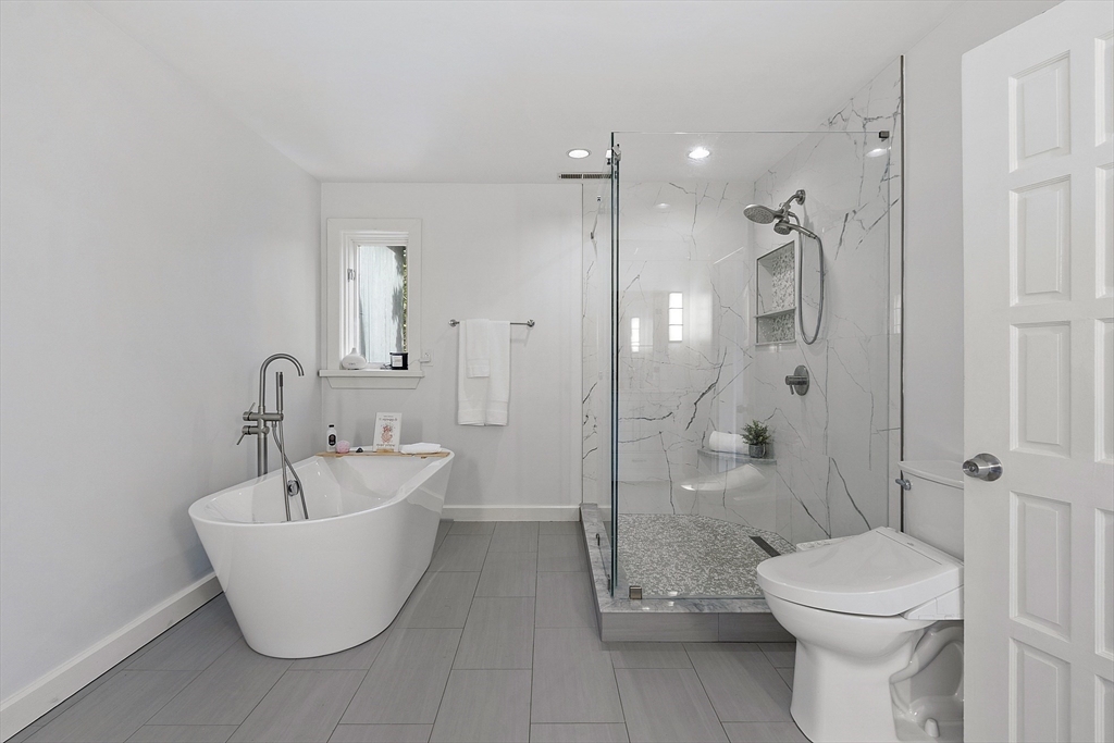 7 Birch Hill Road Pepperell, MA 01463 - Photo 13 of 42 a bathroom with a white tub shower and toilet