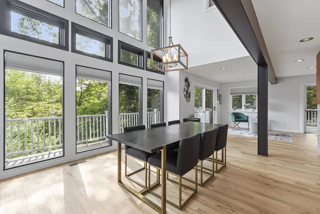 a living room with furniture large window and flat screen tv