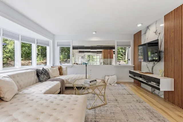a view of dining room with wooden floor and floor to ceiling window