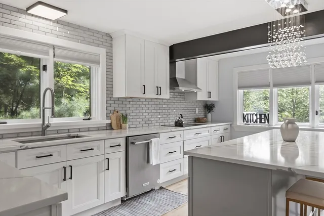 a kitchen with stainless steel appliances kitchen island granite countertop a sink and cabinets