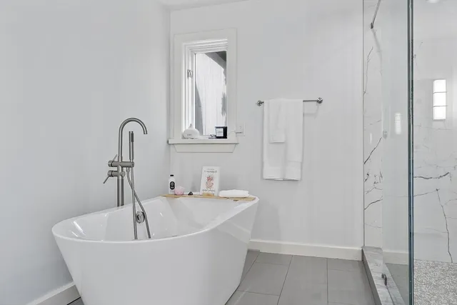 a bathroom with double sink and a mirror