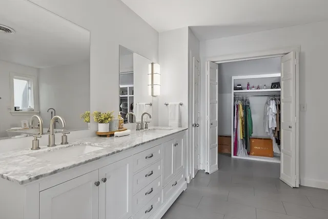 a view of walk in closet with clothes
