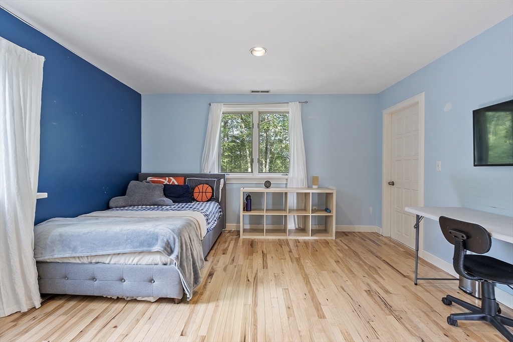 7 Birch Hill Road Pepperell, MA 01463 - Photo 28 of 42 a bedroom with a bed and a table