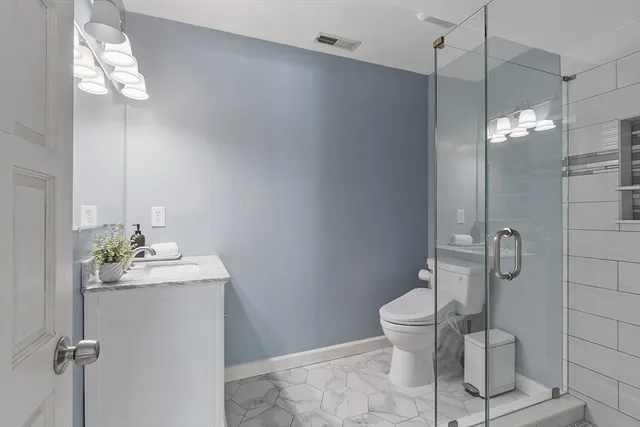 a bedroom with a bed and a chair