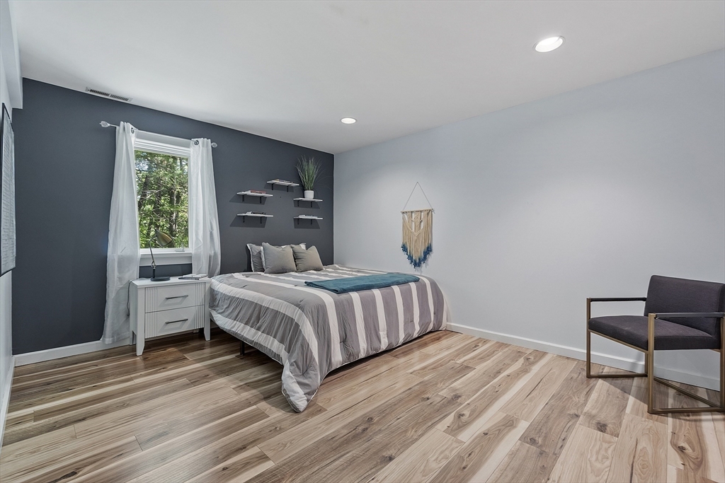 7 Birch Hill Road Pepperell, MA 01463 - Photo 33 of 42 a bedroom with a bed and a chair