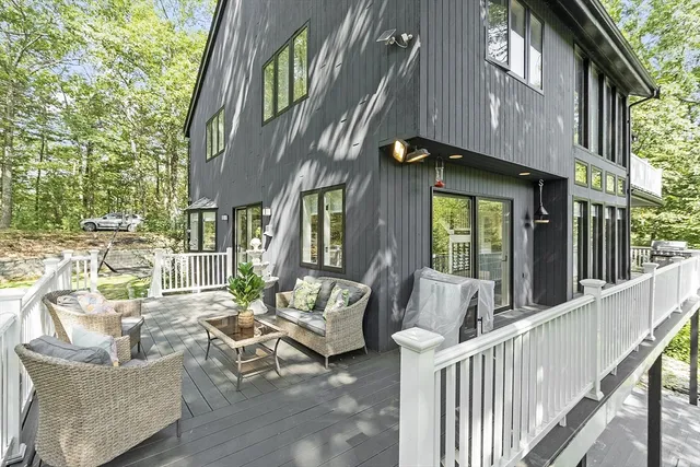 a view of a house with backyard and sitting area