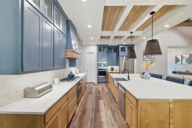 a large kitchen with a large counter top appliances and cabinets