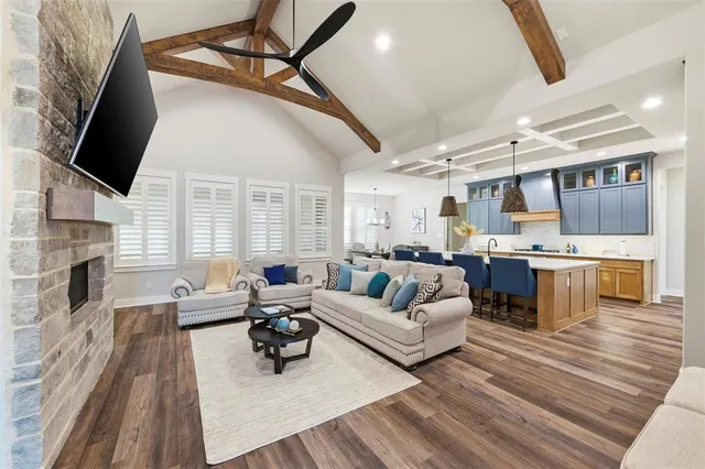 a living room with fireplace furniture and a flat screen tv