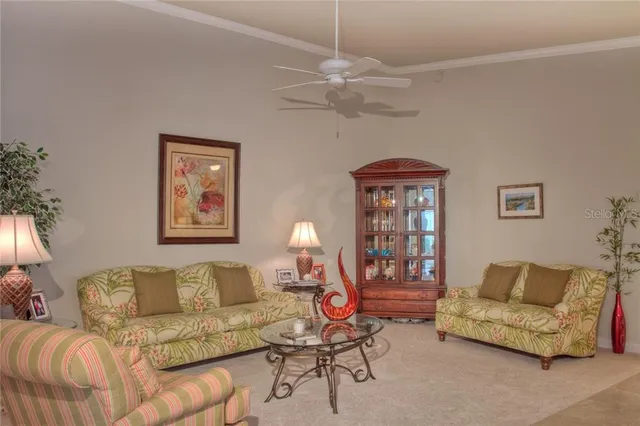 a living room with furniture a chandelier and a window