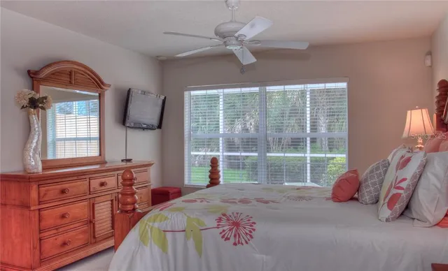a bedroom with a bed dresser and a window