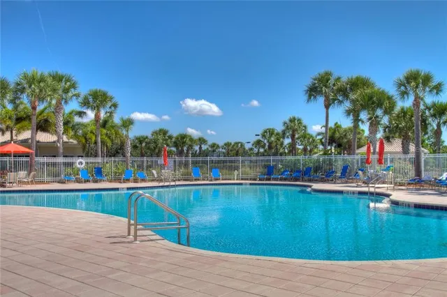 a view of swimming pool with outdoor seating and plants
