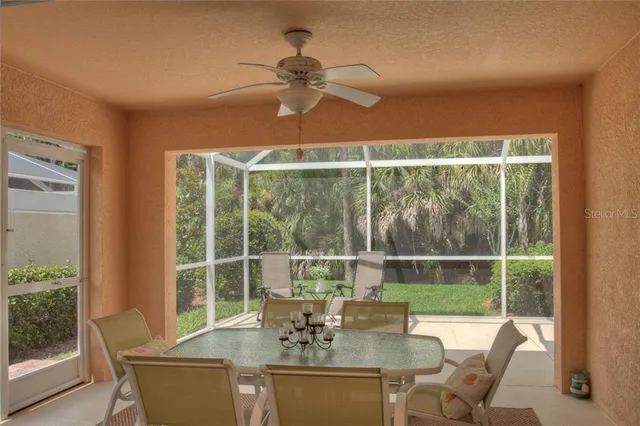 a dining room with furniture a chandelier and window