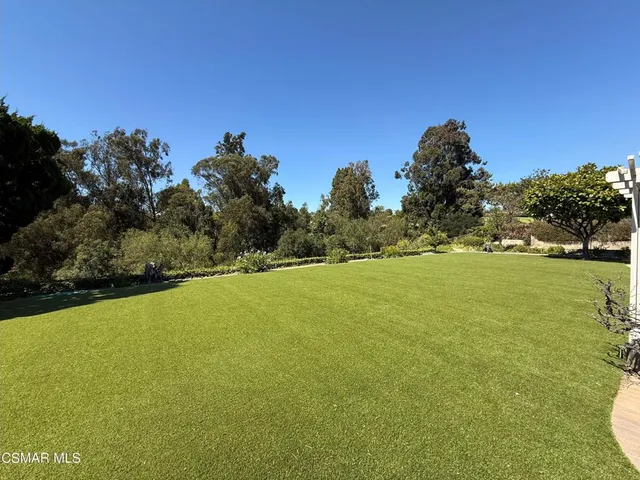 a view of a green field with clear sky