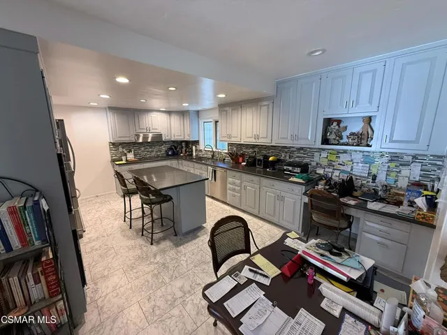 a kitchen with a sink appliances and cabinets