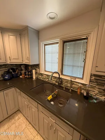 a kitchen with a sink appliances and cabinets