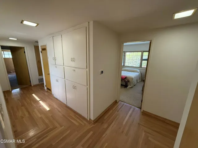 a view of hallway with wooden floor