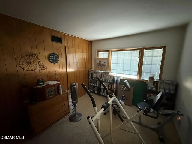 a view of a workspace with furniture and windows