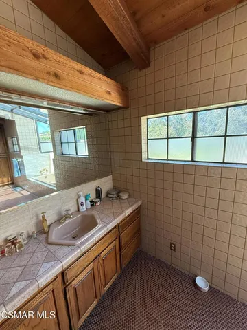 a utility room with a sink and a mirror