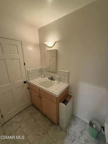 a bathroom with a shower a toilet and a sink