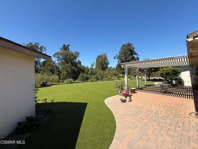 a view of a patio with table and chairs potted plants with wooden floor