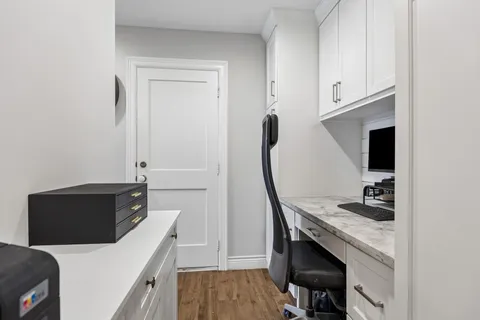 a kitchen with a refrigerator and a stove top oven