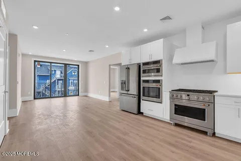 a view of an empty room with a fireplace and a window