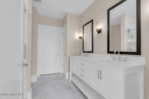 a bathroom with double sink and a mirror