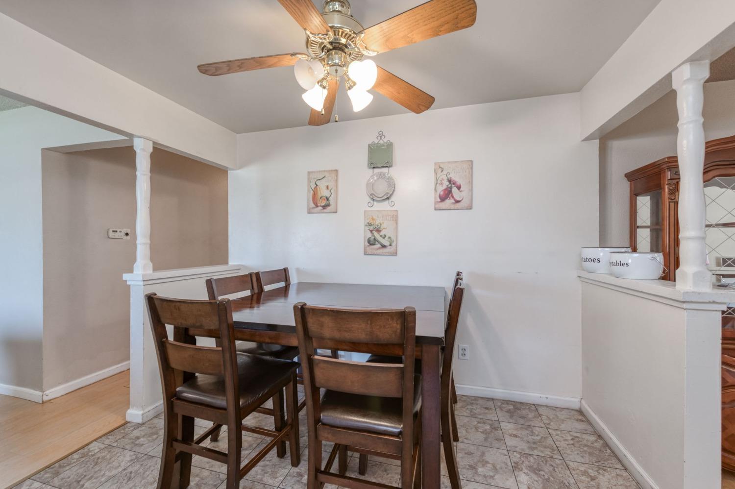 1325 Terry Avenue Clovis, CA 93612 - Photo 13 of 28 a view of a dining room with furniture and a chandelier fan