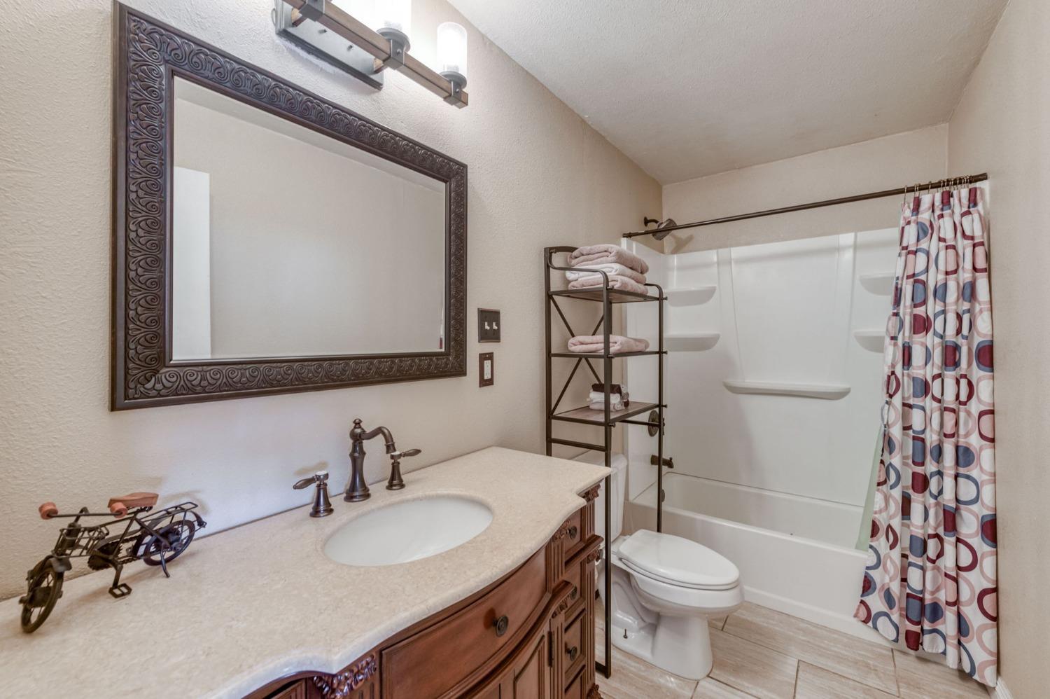 1325 Terry Avenue Clovis, CA 93612 - Photo 17 of 28 a bathroom with a sink toilet and shower