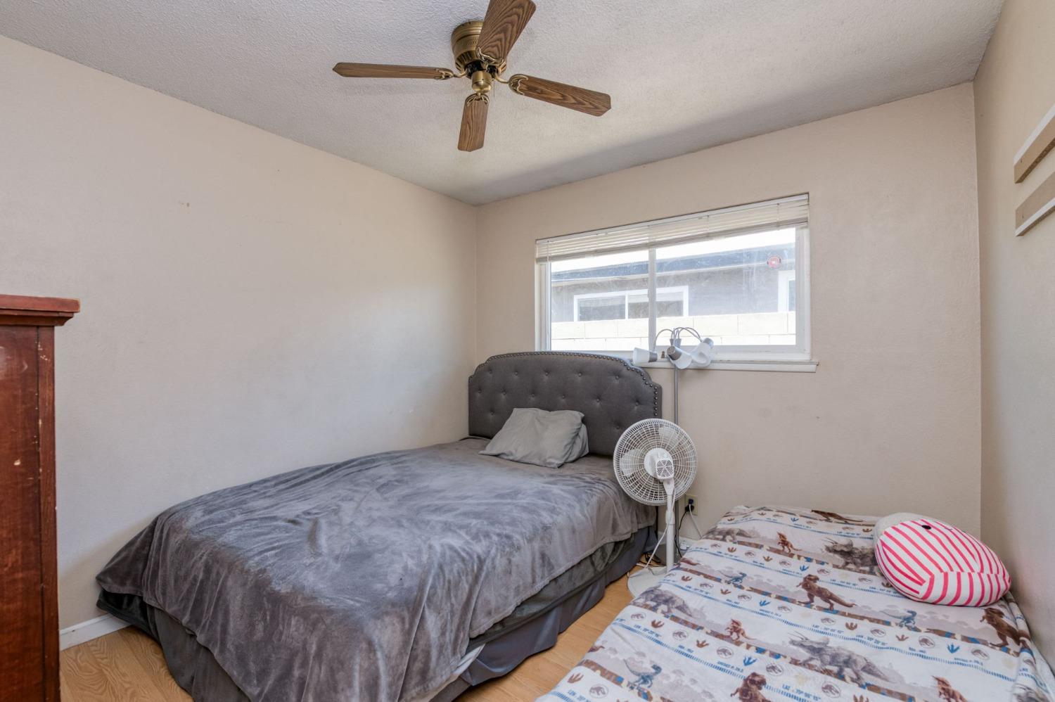 1325 Terry Avenue Clovis, CA 93612 - Photo 18 of 28 a bedroom with a bed and window