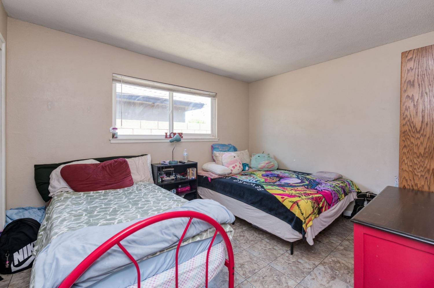1325 Terry Avenue Clovis, CA 93612 - Photo 19 of 28 a bedroom with two beds and a window